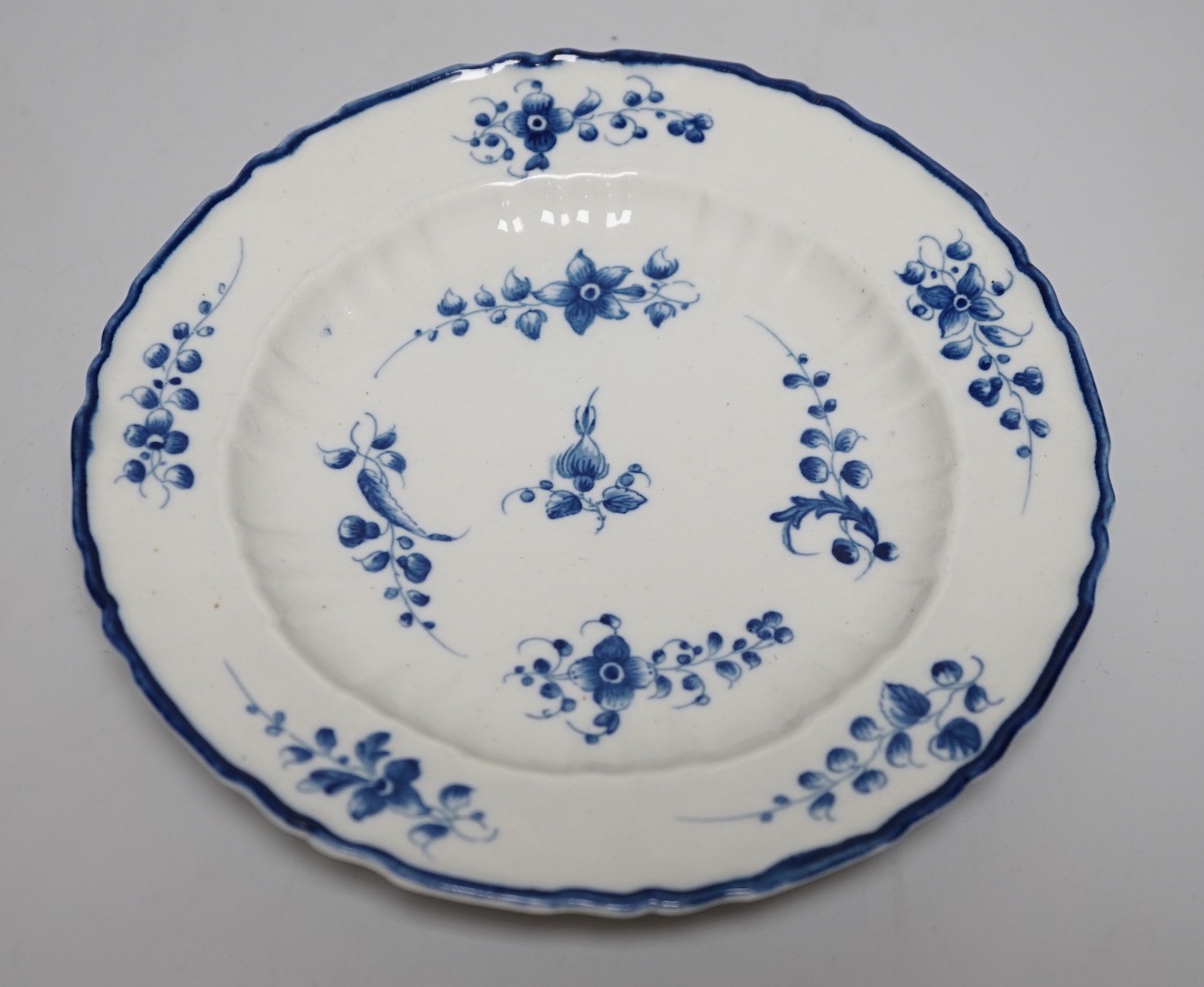 An 18th century Caughley plate painted with bright sprigs, impressed SALOPIAN, 19.5cms diameter